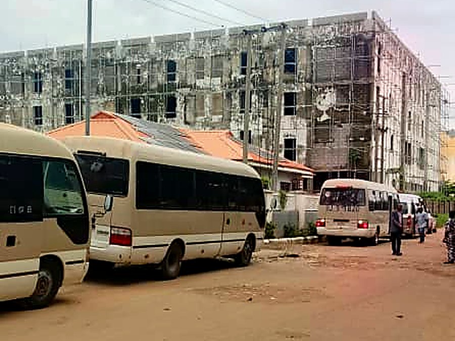 Three Toyota Coaster buses parked between scheduled runs